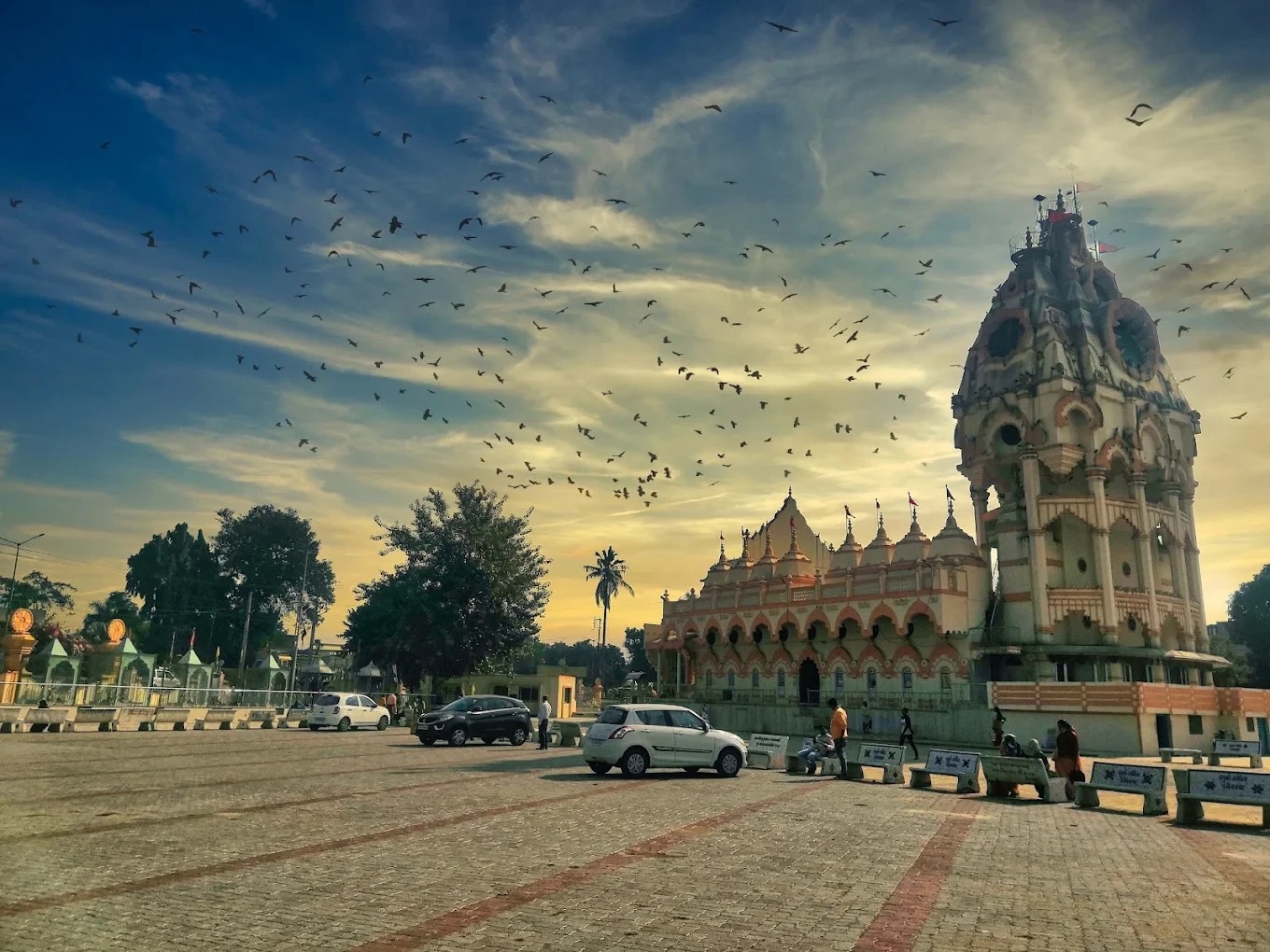 Surya Mandir Borsad at sunset with birds in flight