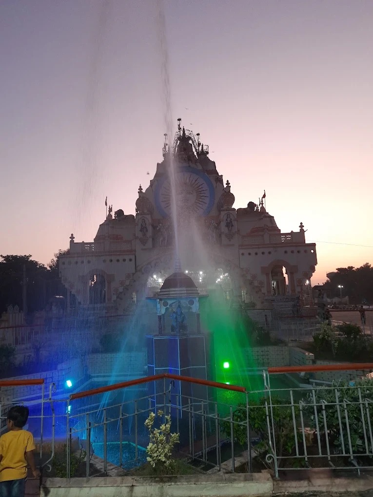 Temple fountain illuminated with coloured lights at dusk